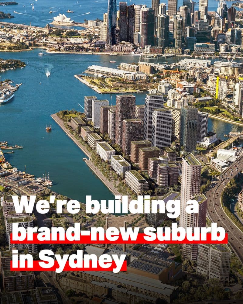 Sunset render of Bays West precinct from across the harbour, showing residential towers against the Sydney skyline.