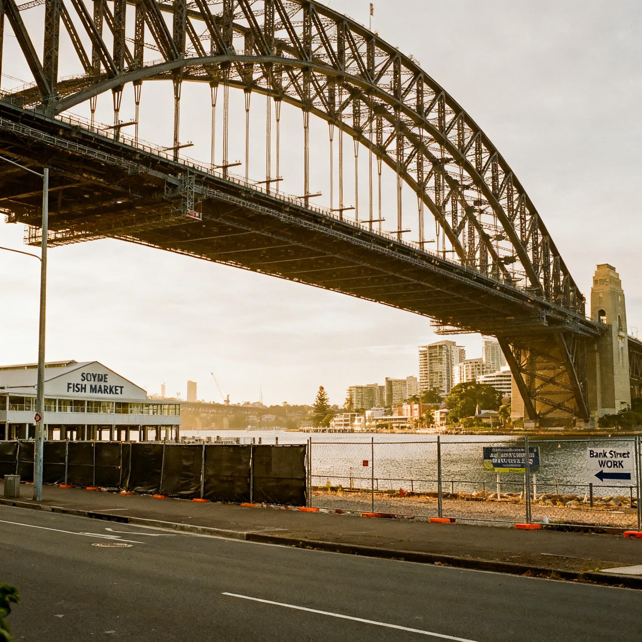 AI-generated aerial view of a Sydney waterfront precinct with staged construction zones and public promenade