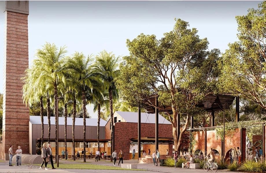 Heritage industrial precinct with retained brick chimney, adaptive reuse buildings and landscaped public spaces