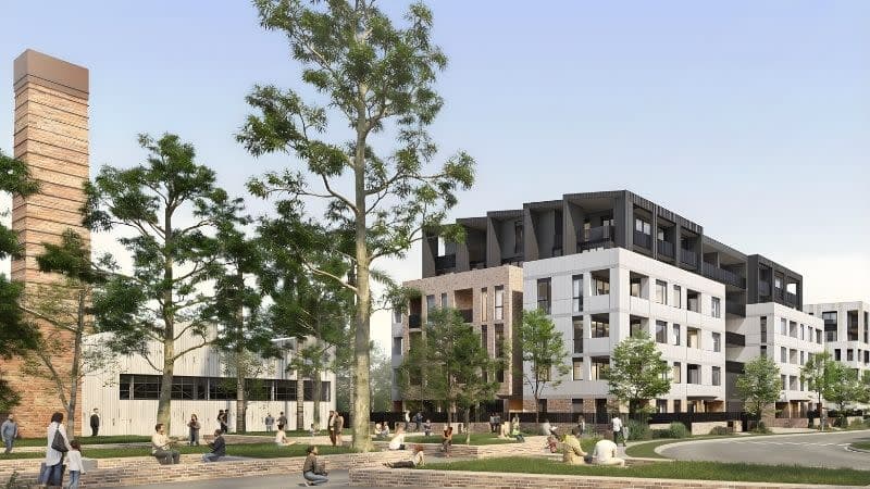 Mid-rise apartments with retained industrial chimney and landscaped public realm at The Works Corrimal